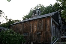 The image is of a wooden barn