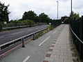 The A312 Harlington Road East and a walkway running over the Waterloo-Reading rail line near Feltham