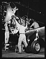 Hanging an engine on a BT-13 Valiant trainer at the Vultee aircraft plant, Downey, California