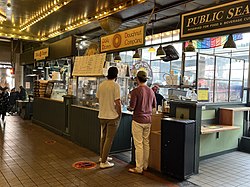 Photograph of a stall with a display case at a market