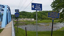 a picture of the marker with the river that was forded, and the present bridge over the river, in the background