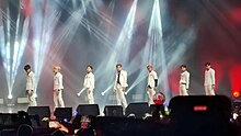 Seven boys in white suits