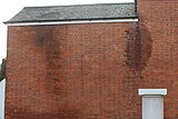 Porous bricks combined with poorly-maintained rainwater goods leading to penetrating damp.