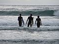 Surfers walking out at Cardiff Reef