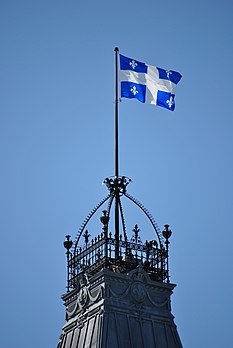 Le drapeau du Québec flottant au dessus du Parlement à Québec (Canada). Le 24 juin est le jour de la Fête nationale du Québec. (définition réelle 2 592 × 3 872)