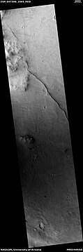 This long, straight ridge may be a dike that has been exposed by erosion. It was initially formed by magma moving under the surface. The picture was taken with HiRISE under the HiWish program.