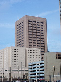 Street level view of group of buildings with tower, jail, parking garage