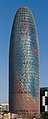 Image 8 Torre Agbar Photo credit: Diliff The Torre Agbar is a landmark skyscraper and the third tallest building in Barcelona, Spain. It was designed by French architect Jean Nouvel, who stated that the shape of the Torre Agbar was inspired by the mountains of Montserrat that surround Barcelona, and by the shape of a geyser of water rising into the air. Its design combines a number of different architectural concepts, resulting in a striking structure built with reinforced concrete, covered with a facade of glass, and over 4,500 window openings cut out of the structural concrete. More selected pictures