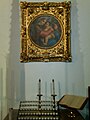 Madonna and Child with a votive candle rack and prie-dieu in a Methodist church