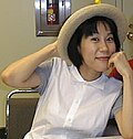 Woman wearing a white blouse and a straw hat