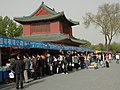 People at a temple fair to buy books