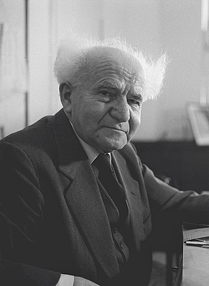 Black-and-white photograph of David Ben-Gurion sitting with his arm on a desk