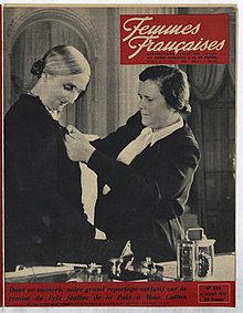 A woman pinning a medal on another woman