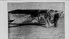 A photograph of Derwent Hall Caine with his Leopard Moth aeroplane at Close Lake Airfield