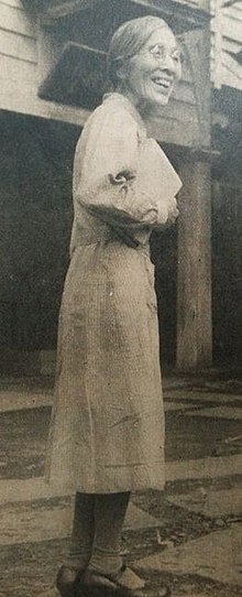 Full-length photo of Ume Tange in a street, smiling.