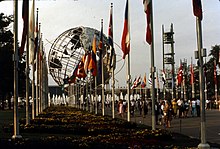 View of the Unisphere, a steel structure depicting the Earth; there are world flags in the foreground