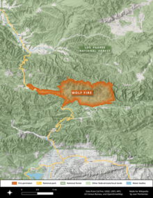 A map shows the Wolf Fireas an orange shape (a thin finger along Highway 33 that broadens abruptly to the east), lying entirely within national forest lands north of Ojai