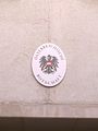 Plaque outside the embassy in German depicting the coat of arms of Austria