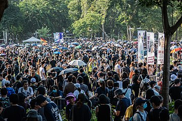 Protesters holding banners and umbrellas