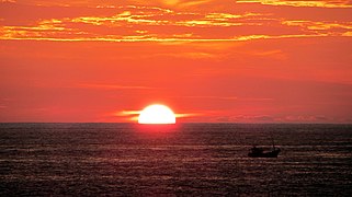 Clear half-disk view of a sunset in Hikkaduwa, Sri Lanka.