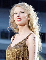 Swift with a portion of the lyrics that read "Where I was born, where I was raised" on her arm.