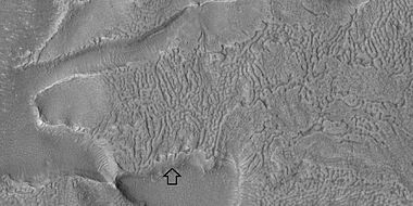 Brain terrain with a view from the side, as seen by HiRISE under HiWish program. Arrow shows where a side view of the brain terrain is visible.