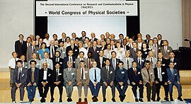 Schopper seated in a group at the Second International Conference on Research and Communications in Physics