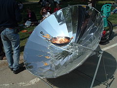 Parabolic solar cooker used to cook Paella.