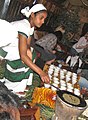 Image 28An Ethiopian woman preparing Ethiopian coffee at a traditional ceremony. She roasts, crushes, and brews the coffee on the spot. (from Culture of Africa)