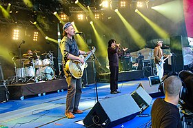 Killing Joke performing at the 2009 Ilosaarirock Festival. From left to right: Ferguson (background), Walker, Coleman, Youth