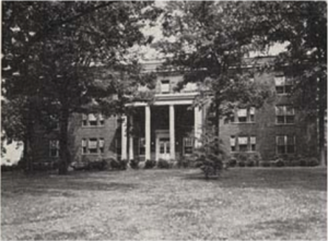 A brick, neoclassical hospital building.