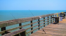 Myrtle Beach State Park's pier with fishing poles cast off the side