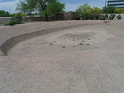 This was a Hohokam ballpark where they played ceremonial ball games. The villagers stood on top of the surrounding mound to observe the game.