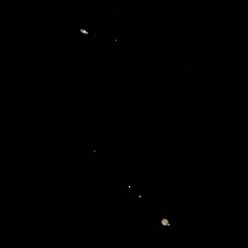 Photograph of the great conjunction of 2020 taken two days before closest approach with the four Galilean moons visible around Jupiter. (Titan can also be seen to the right of Saturn.)