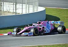 Sergio Pérez driving the pink- and white-liveried Racing Point RP20, an open-wheeled formula race car.