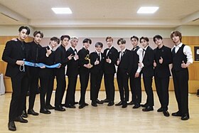 The thirteen members of Seventeen receiving a cultural award