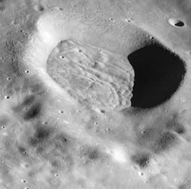 Mandelʹshtam Q from Apollo 16. The crater has a floor that is heavily lineated and grooved, but this structure is subdued rather than sharp and is contained wholly within the crater. The cracked floor is typical of a variety of craters that occur in the highlands away from the mare basins. (partial NASA caption)