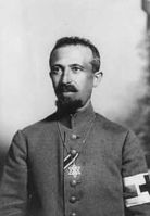 Military Field Rabbi Dr. Aaron Tänzer during World War I, with the ribbon of the Iron Cross.[85] The brassard of the red cross shows him as noncombatant. He wears the Star of David as insignium