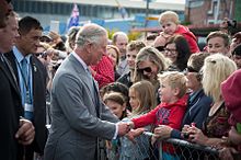 Charles shaking hands with a crowd