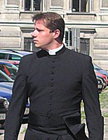 A Roman Catholic seminarian wearing a cassock with a clerical collar