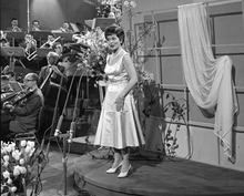 Photo of Lys Assia, the first winner of the Eurovision Song Contest, performing at the third contest in 1958.
