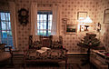 Interior of the Pickett House showing a sofa chair and windows looking out to the front