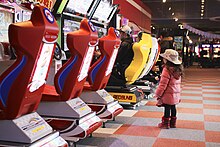 Seats for Mario Kart games (left) in a Japanese arcade