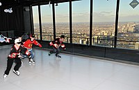 Children skate on an artificial ice rink erected on along the north-facing end of the observation deck in late-2011