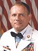 Head of a man in military dress uniform, wearing a bow tie over a white jacket. Medal of Honor around his neck and other medal ribb0ns on his chest