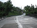 Slanted bridge at bottom of hill, on PR-438 over Río Culebrinas in barrio Magos