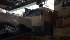 Mostly rolls of toilet paper in their packaging. You can see the rest of the store faded in the background, between some of the packages.