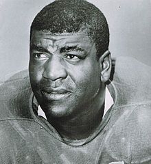 Black and white head shot from the shoulders up of Dick "Night Train" Lane.