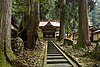 Long wooden stairway from the front gate up to the Buddha hall, surrounded by 700-year-old cedar trees