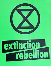 The words Extinction Rebellion beneath an hourglass symbol on a green background